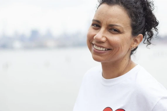 A kidney patient is smiling at the camera.