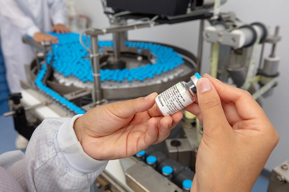 A scientist holding a vial in the laboratory in Saluggia, Italy
