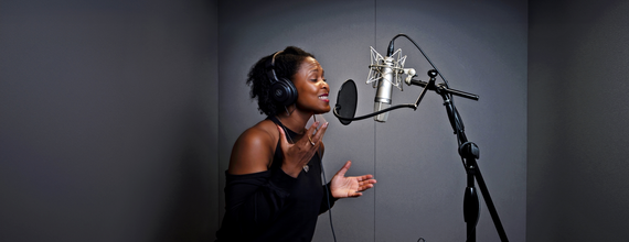 Shanelle Gabriel rehearses a poem in a studio.