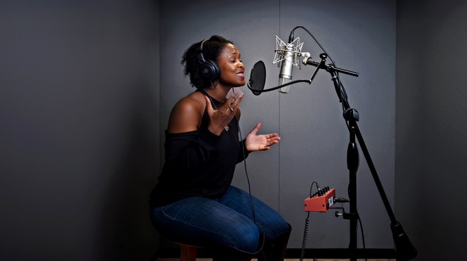 Shanelle Gabriel rehearses a poem in a studio.