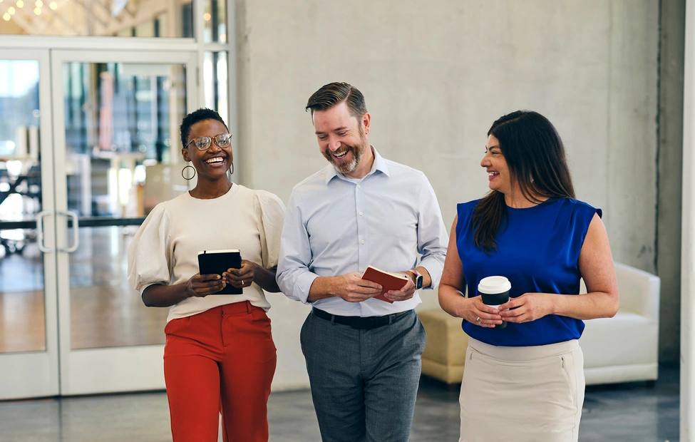 Three business people laughing